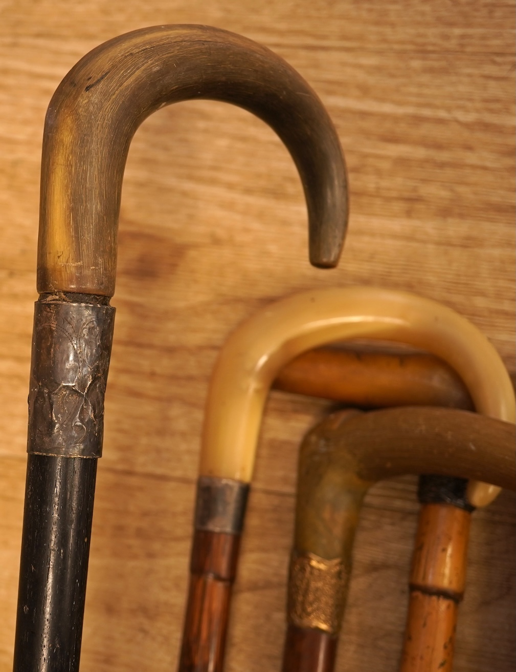 A collection of seven horn handles walking sticks some gold and white metal mounted